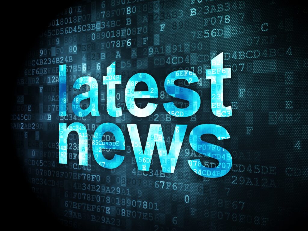The words "latest news on a pixelated digital background.