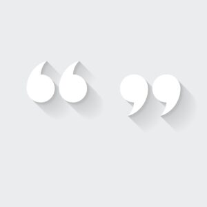 White icon of "quotation marks" in a flat design style isolated on a gray background and with a long shadow effect.